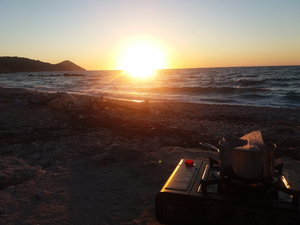 Cooking dinner with a sunset, Elba.